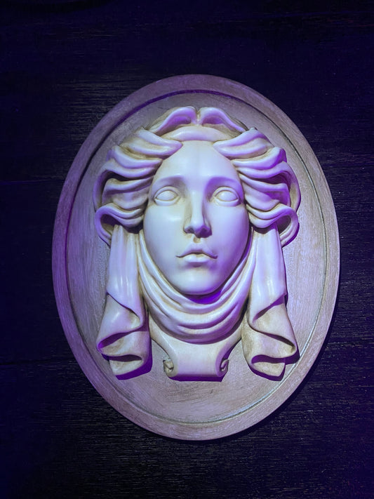 Madame Leota stone plaque with green led eyes.